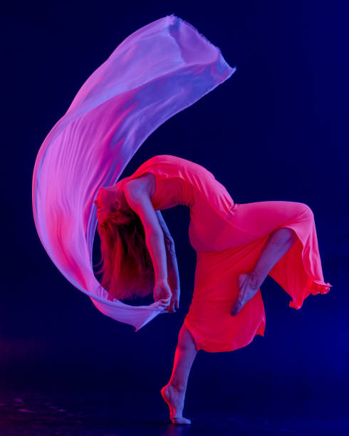 istock Dancer in red dress on black background 1271594985