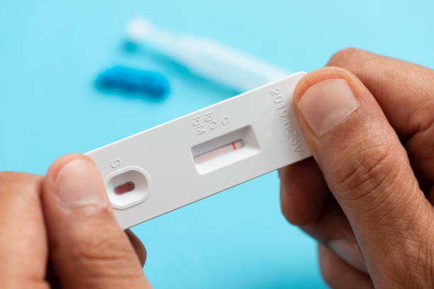 istock Man Looking At Coronavirus Rapid Test Result 1271595244