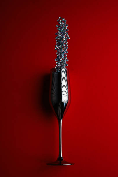 istock wine glass on red background with confetti 1271597437