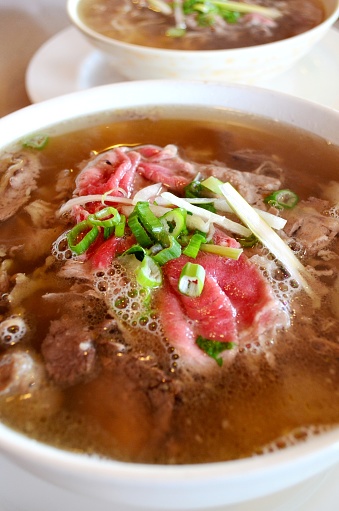 Vietnamese rice noodles in soup with raw beef