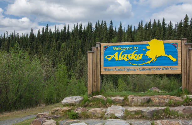 Big wooden sign on Alaskan highway entering Alaska