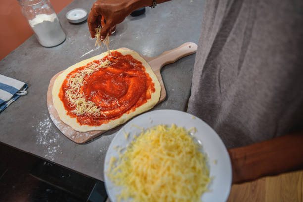 istock Hispanic Man Preparing Pizza in Domestic Kitchen 1271602983