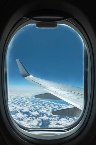 istock View from airplane window on wing and sky with clouds 1271605184