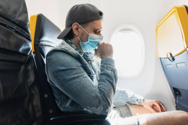istock Man wearing prevention mask during a flight inside an airplane 1271605827