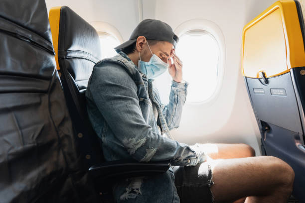 istock Man wearing prevention mask during a flight inside an airplane 1271605916