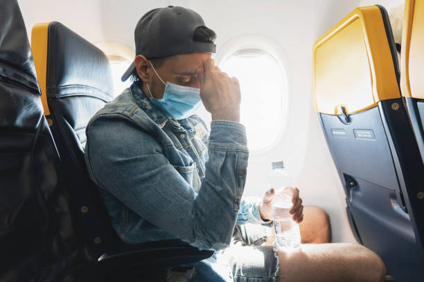 istock Man wearing prevention mask during a flight inside an airplane 1271605926