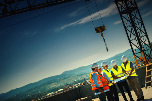 istock Group of contractors supervising building process 1271610470