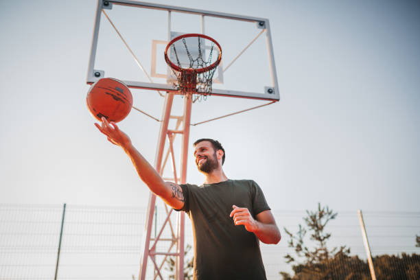 istock Handsome Young Man Spinning Basketball On Finger 1271610479