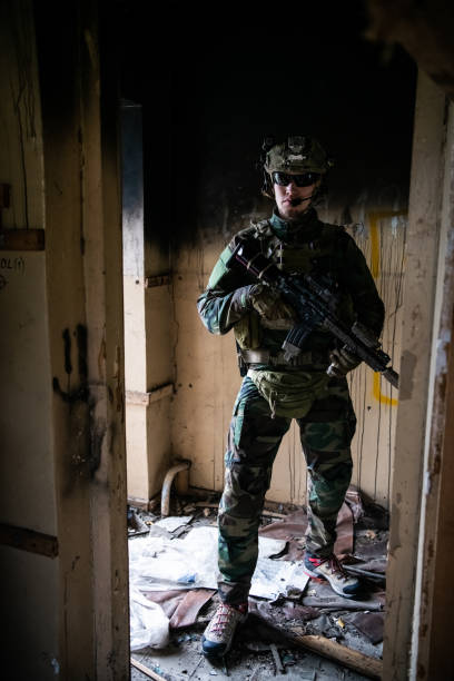 istock Close-up of a professional fully equipped soldier looking at camera 1271611340