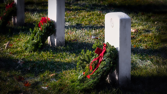 Wreaths on graves at a nation cemetery in northern Virginia cemetery.