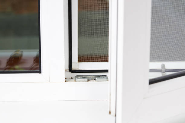 istock handyman adjusting white pvc plastic window indoors. worker using screwdriver to repair upvc window. homework maintenance 1271613568