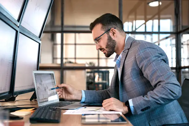 Photo of Confident businessman analyzing stat and dynamic on forex charts