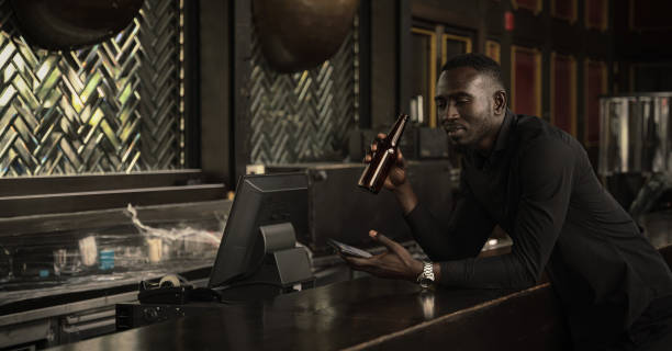 african american businessman relax and enjoy drinking bottle of beer at counter bar in club and bar african american businessman relax and enjoy drinking bottle of beer at counter bar in club and bar black people bar stock pictures, royalty-free photos & images