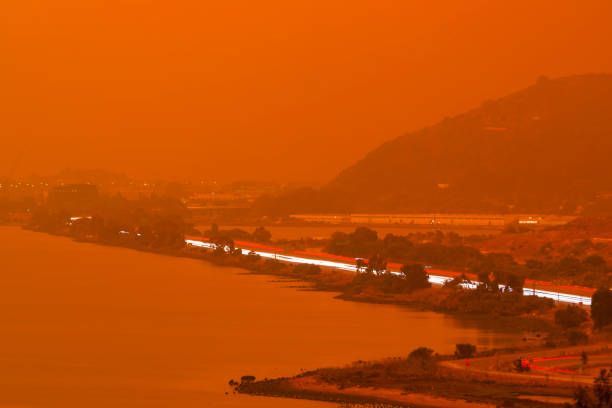 Orange haze over San Francisco Bay on September 9 2020 from record wildfires in Californa, ash and smoke during daytime Thick orange haze above San Francisco Bay on September 9 2020 from record wildfires in Californa, daytime view of ash and smoke over the Bay Area heat haze stock pictures, royalty-free photos & images