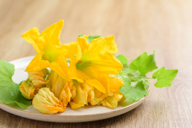 istock Yellow pumpkin flowers on plate 1271634244