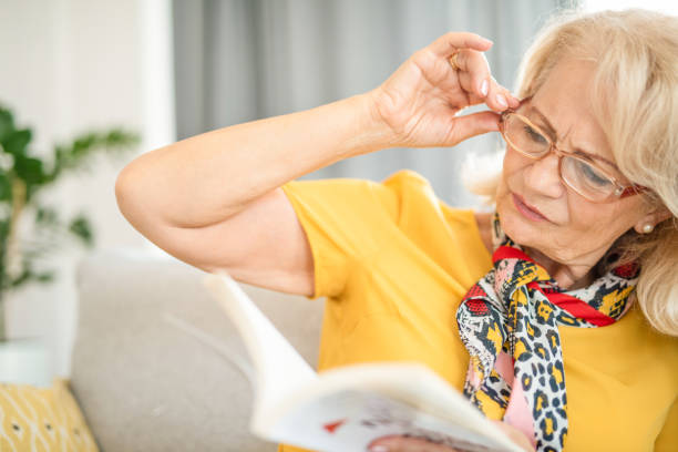 istock Mature woman finding it hard to read a book. 1271635630