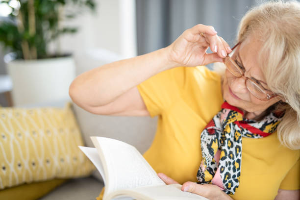 istock Mature woman finding it hard to read a book. 1271635776