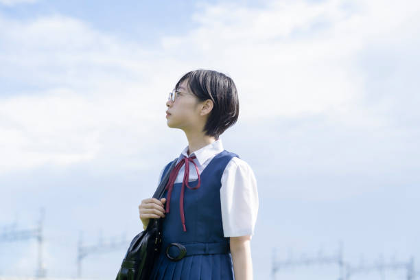 istock High school girl looking up at the sky 1271638076