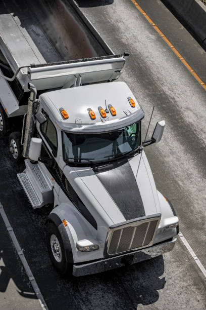 istock Big rig tip semi truck with empty dump trailer running on the road 1271640930