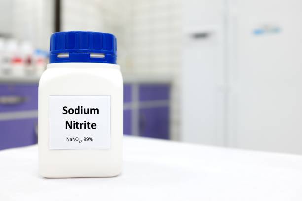 Selective focus of a bottle of sodium nitrite preservative chemical compound. White laboratory background with copy space. Food additive nitrites. Selective focus of a bottle of sodium nitrite preservative chemical compound. White laboratory background with copy space. Food additive nitrites. sodium stock pictures, royalty-free photos & images