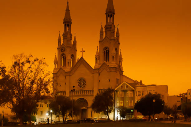 Dark orange sky from the California wildfires creates a surreal scene over Saint Peter & Paul church in North Beach.