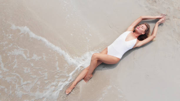 istock Woman Lying On Beach 1271644173
