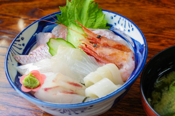 istock Bowl of rice topped with sashimi 1271647311