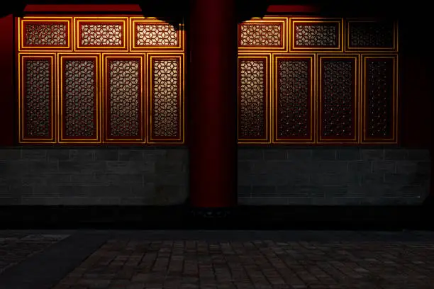 Photo of Part of Chinese traditional palace building, resplendent red painted windows decorated with golden frame and grid