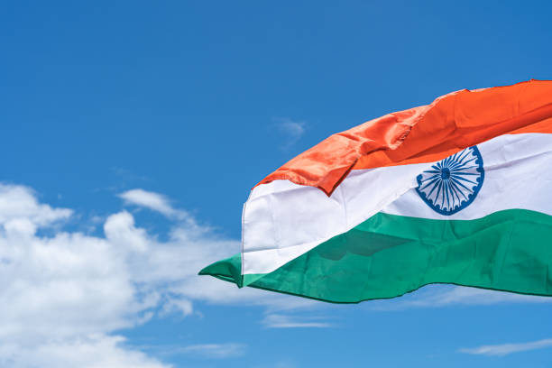 istock Waving India flag under blue sky background. 1271650263