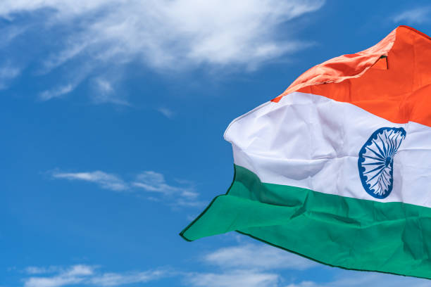 istock Waving India flag under blue sky background. 1271650266
