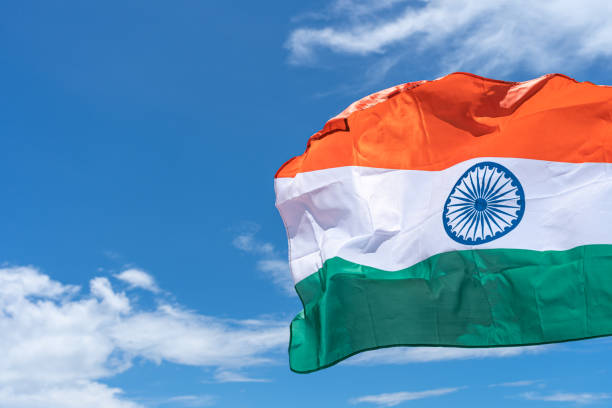 istock Waving India flag under blue sky background. 1271650268