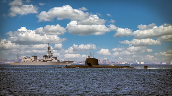 Yokosuka, Kanagawa / Japan - August 30, 2020:  A Japan Maritime Self-Defense Force (JMSDF) submarine returns home through Tokyo Bay with a JMSDF destroyer in the background.