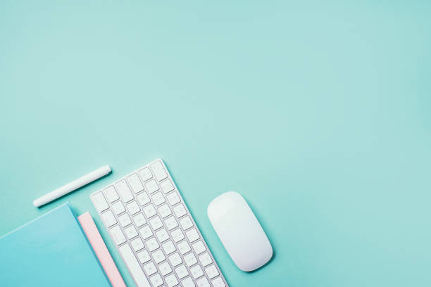 istock White mouse, keyboard, notebook, pen on blue background. Top view. Copy space. Flat lay. Remote job, work. Home office workspace. Feminine workspace. Blogger, business concept. Mock up 1271654477