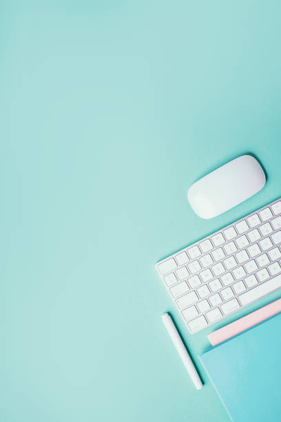 istock Home designer office workspace. White mouse, keyboard, notebook, pen on blue background. Top view. Copy space. Flat lay. Remote job, work. Feminine workspace. Blogger, business concept. Mock up 1271654478
