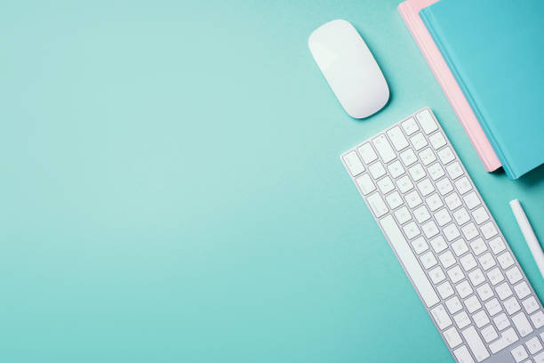 istock Home designer office workspace. White mouse, keyboard, notebook, pen on blue background. Top view. Copy space. Flat lay. Remote job, work. Feminine workspace. Blogger, business concept. Mock up 1271654488