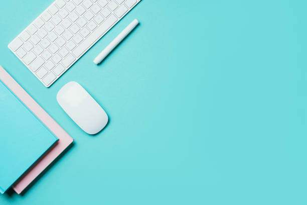 istock White mouse, keyboard, notebook, pen on blue background. Top view. Copy space. Flat lay. Remote job, work. Home office workspace. Feminine workspace. Blogger, business concept. Mock up 1271654496