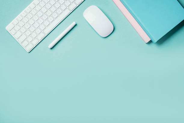 istock Home designer office workspace. White mouse, keyboard, notebook, pen on blue background. Top view. Copy space. Flat lay. Remote job, work. Feminine workspace. Blogger, business concept. Mock up 1271654497