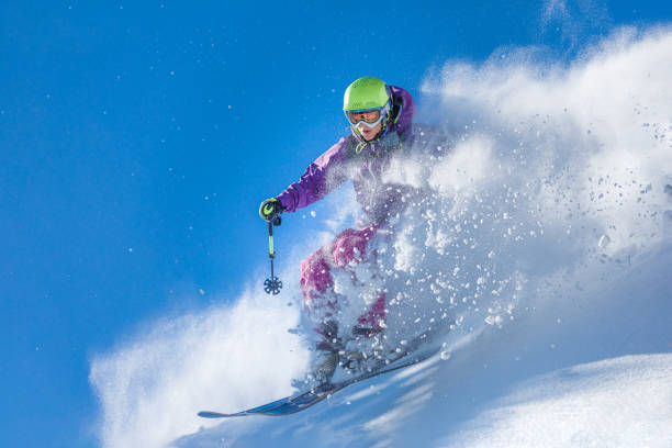 Freeride skiing Young woman jumping over the fresh powder snow extreme skiing stock pictures, royalty-free photos & images
