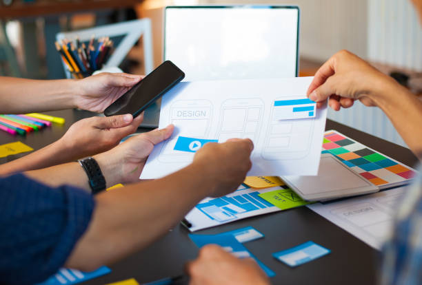 istock Web designers brainstorm ideas to design mobile applications. 1271658272