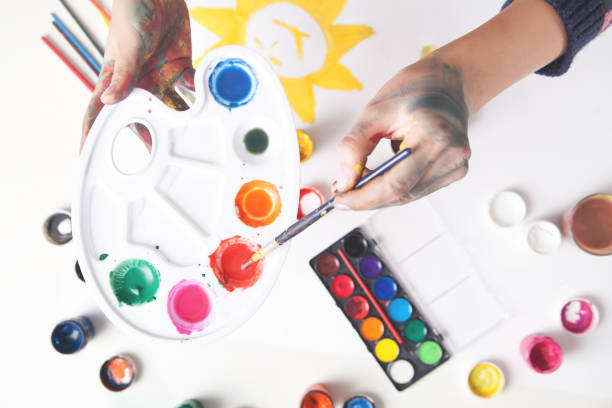 istock Paints on the desk. Painter holding brush. Work, Lifestyle 1271659969