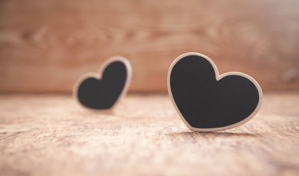 istock Wooden hearts on wooden table. 1271659978