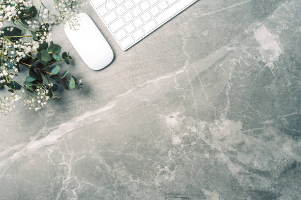 istock Feminine workspace. White computer keyboard, mouse, gypsophila flowers, eucalyptus flowers on marble background. Top view. Copy space. Flat lay. Blogger, business concept. Mock up. Birthday, Woman day. 1271662338