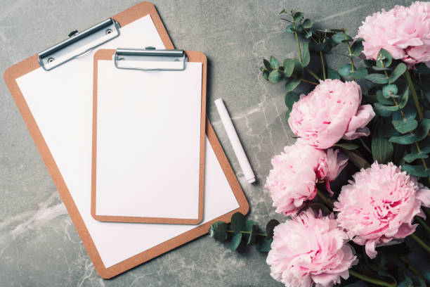 istock Feminine workspace with notebook, pink peony, eucalyptus flower on marble background. Top view, copy space. Blogger, feminine business concept. Flat lay. Birthday, Woman day. Mock up 1271663462
