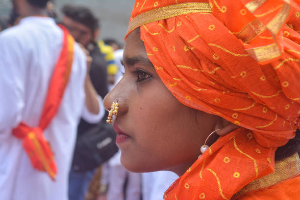 Pune, India - September 4, 2017: Closeup of a girl wearing a nath / nose ring with her traditional ethnic clothes. Ganpati visarjan celebration in pune.