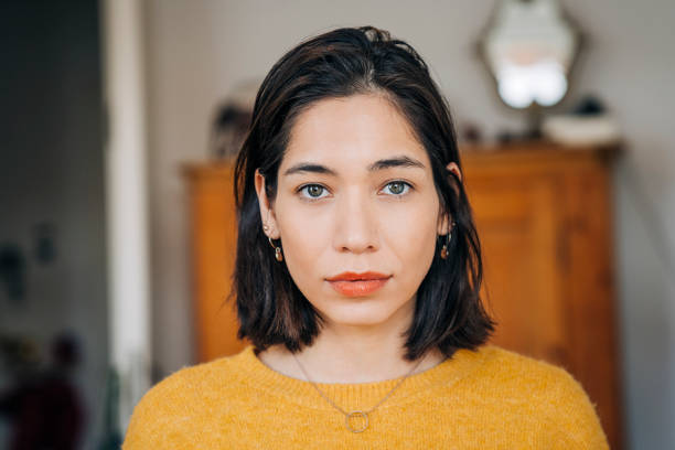 close-up portrait of confident woman at home - beautiful staring caucasian one person imagens e fotografias de stock