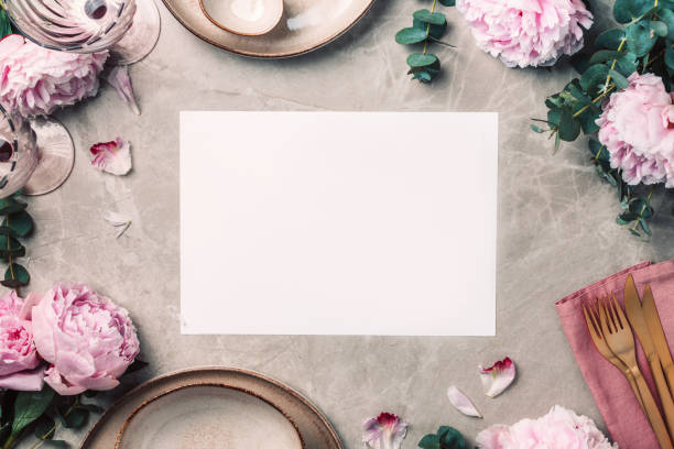 istock Tableware, flowers for serving a festive table, dinner. Stoneware plates, golden cutlery, eucalyptus branches, peony flowers on marble background. Copy space. Flat lay, top view. Table setting 1271666846