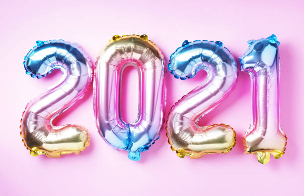 Colorful foil balloons made numbers 2021 on pink background with light bokehs. Banner, copy space. Happy new year celebration party. Greetings and congratulation concept Colorful foil balloons made numbers 2021 on pink background with light bokehs. Banner, copy space. Happy new year celebration party. Greetings and congratulation concept. zero photos stock pictures, royalty-free photos & images