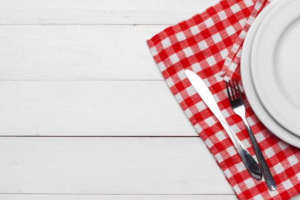 istock Empty plate and towel over wooden table background. 1271668254