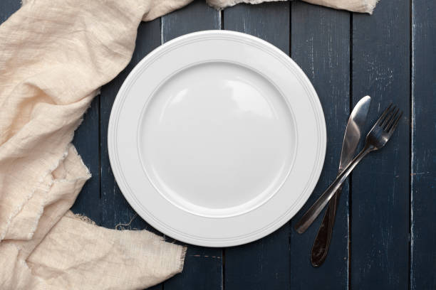 istock Empty plate and towel over wooden table background. 1271668335