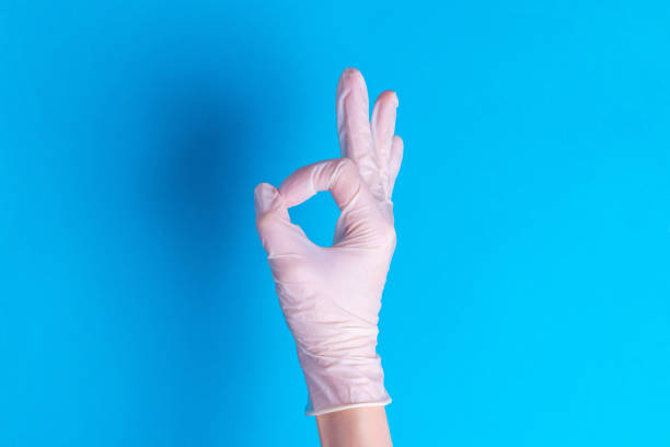 istock Hand in surgical rubber glove sign okay everything will be fine on a blue background 1271669324